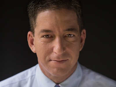 Portrait of Glenn Greenwald, a former constitutional lawyer and co-founder of The Intercept and The Intercept Brasil, with black background and white shirt. Glenn Greenwald is represented for speaking by the Evil Twin Booking Agency