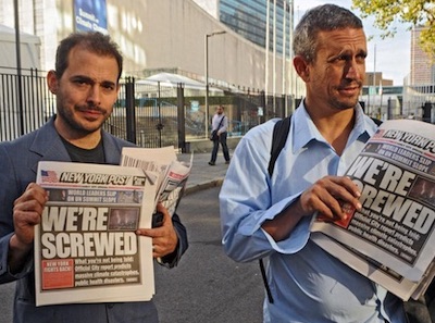 Mike Bonanno and Andy Bichlbaum of the Yes Men holding copies of the environmentally conscious but otherwise pitch-perfect replica of the New York Post they created with a coalition of activists