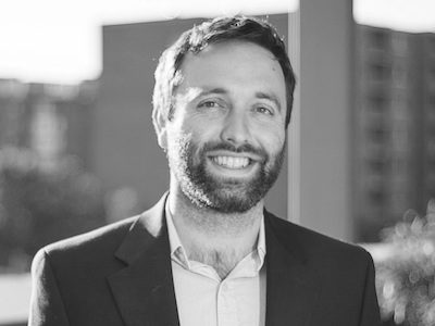 Matt McKibbin, co founder of Decentranet, smiling in a black and white photo