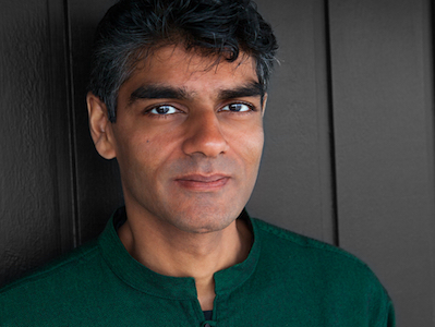 Raj Patel headshot, in a green shirt against a grey background