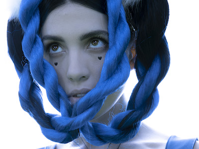 Nadya Tolokonnikova landscape orientation headshot with blue braids
